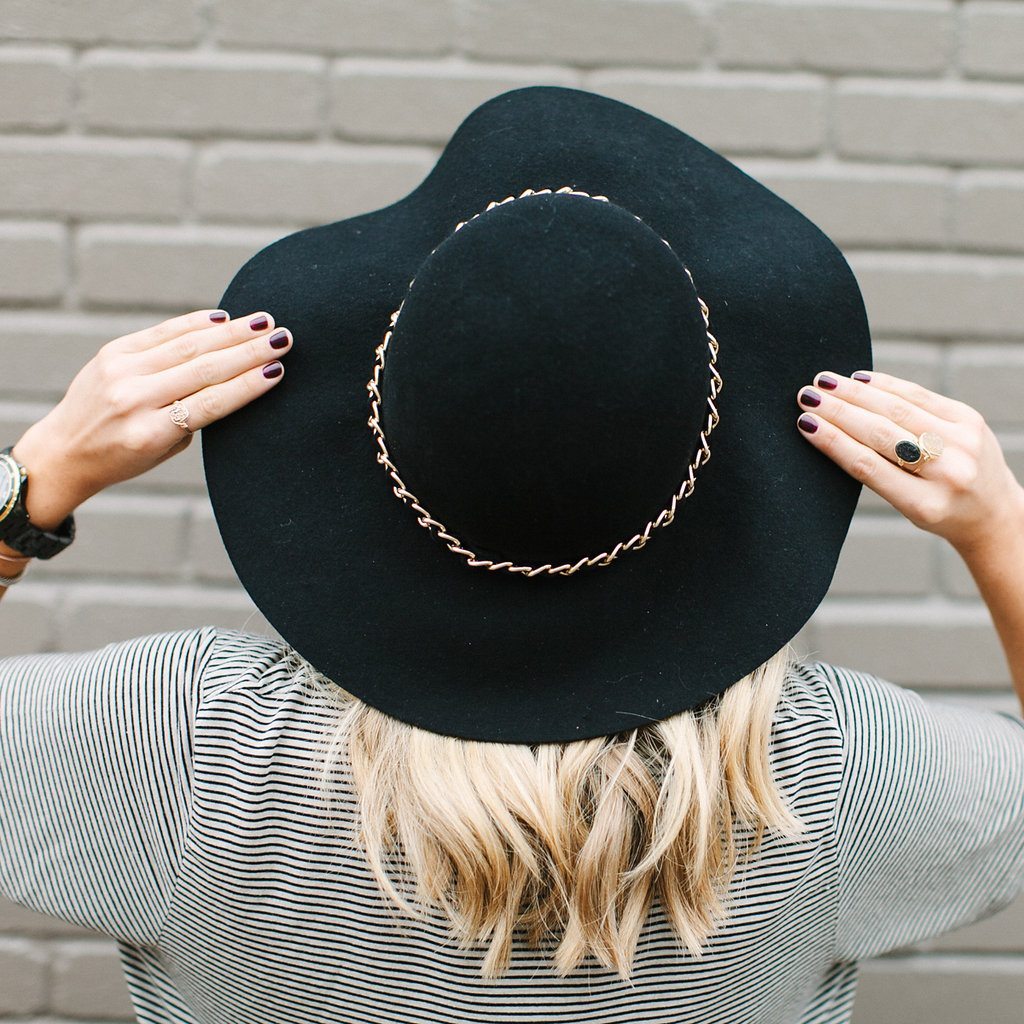 black floppy hat and striped t shirt