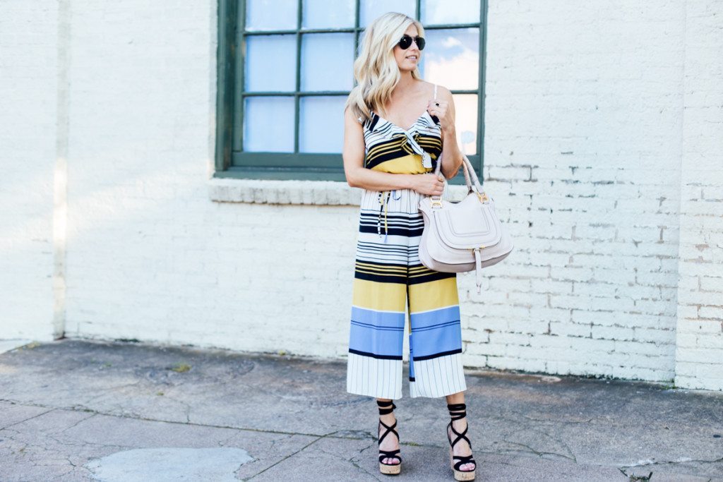 stripe jumpsuit - summer wedding outfit ideas - tan purse