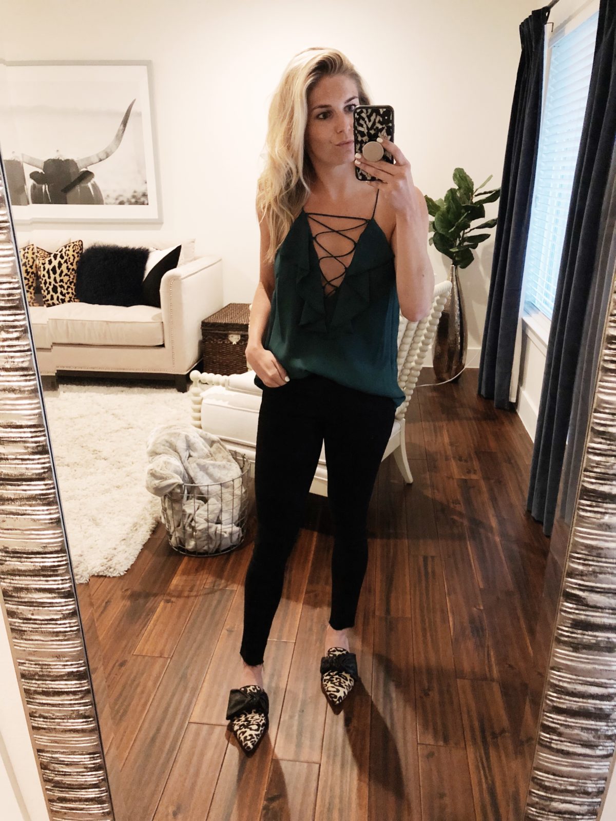 woman wearing WAYF Green Lace-Up Ruffle Cami in Size M (go a size up), Rag & Bone Black Jeans in Size 25 and Louiso Et Cie Leopard Flats  in Size 7 1/2