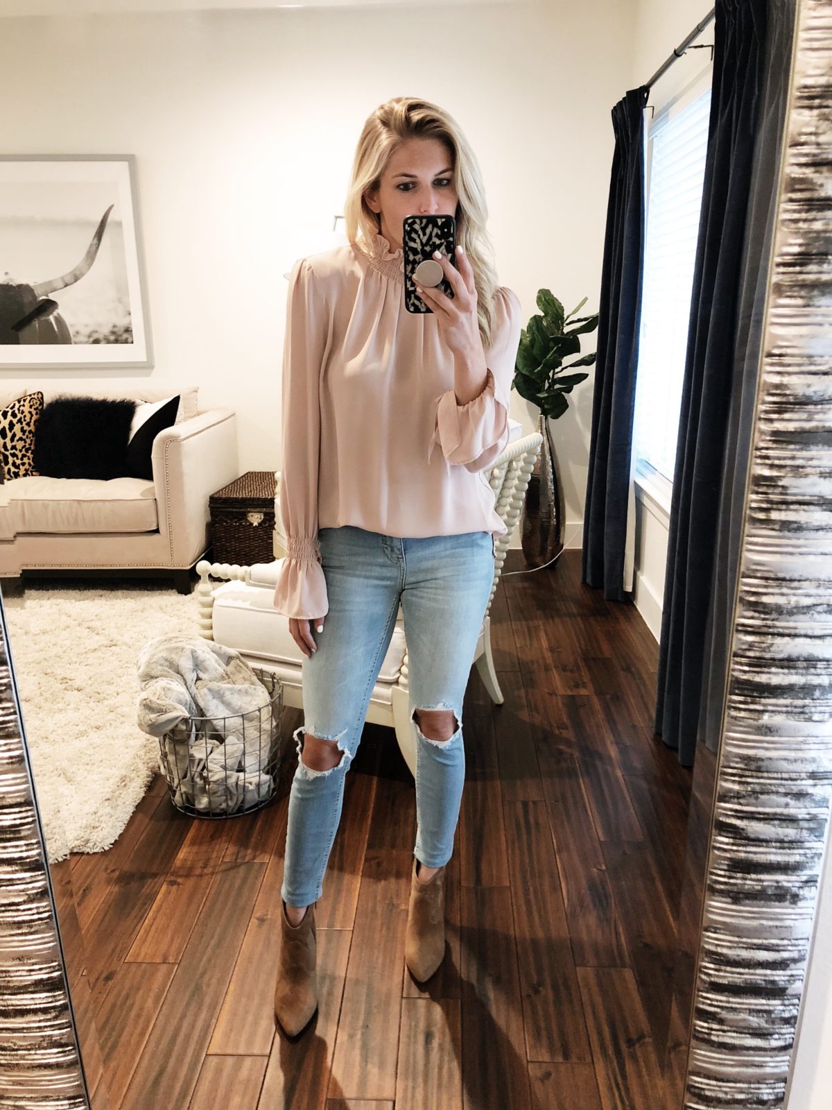 woman wearing Vince Camuto Motiva Bootie in Size 7 1/2, Vince Camuto Smocked Neck Blouse in Size S and Free People High Waist Ankle Skinny Jeans 