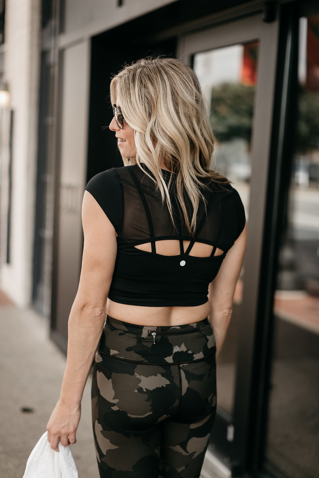 woman wearing camo leggings and black top 