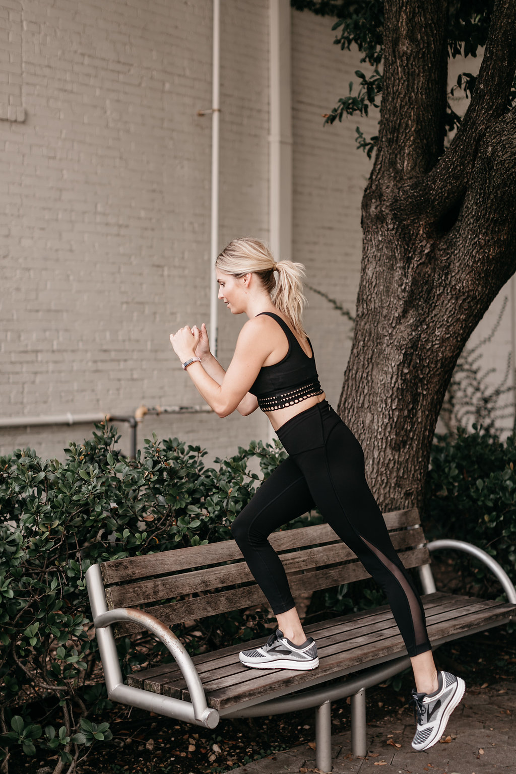woman wearing sportswear, sunglasses, and FITNESS TRACKER TEST and exercising