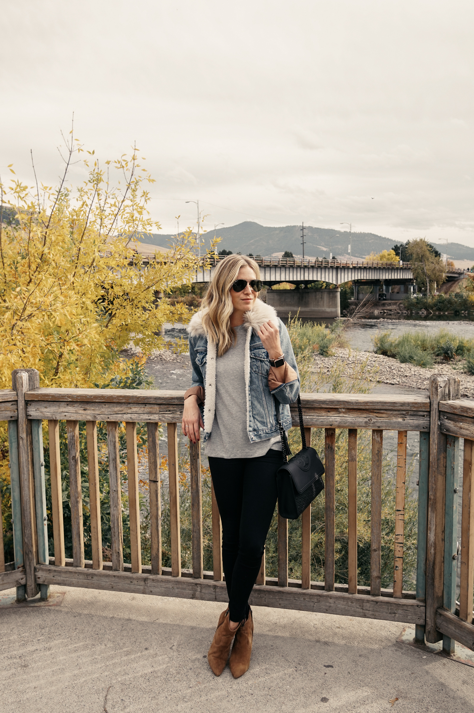 woman wearing denim jacket and tights outside for fall in Montana