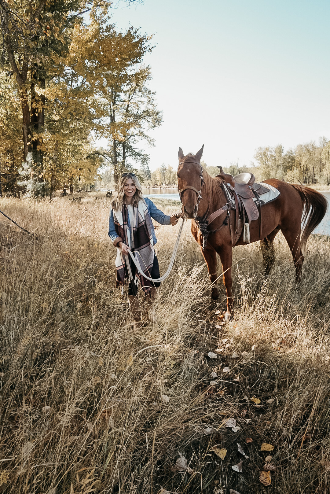 woman and horse in the outdoors for fall in Montana