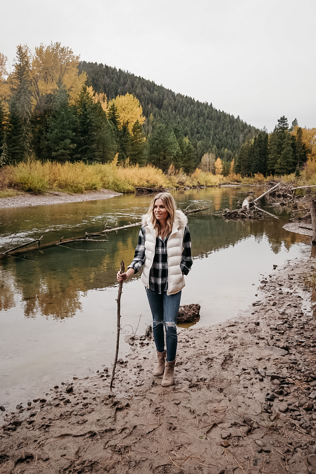 woman trekking near the muddy river banks for fall in Montana