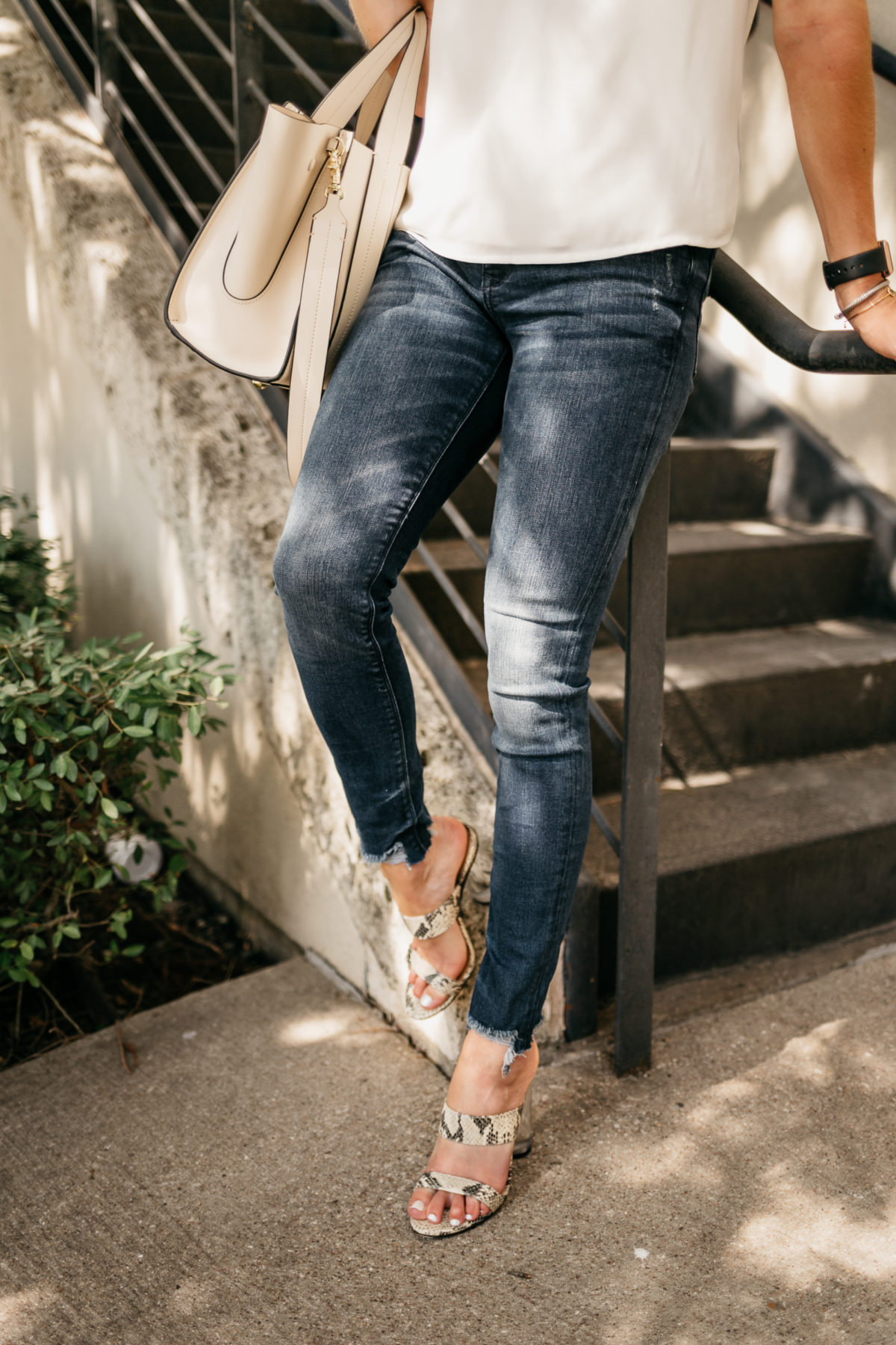 jeans, a blouse, and purse